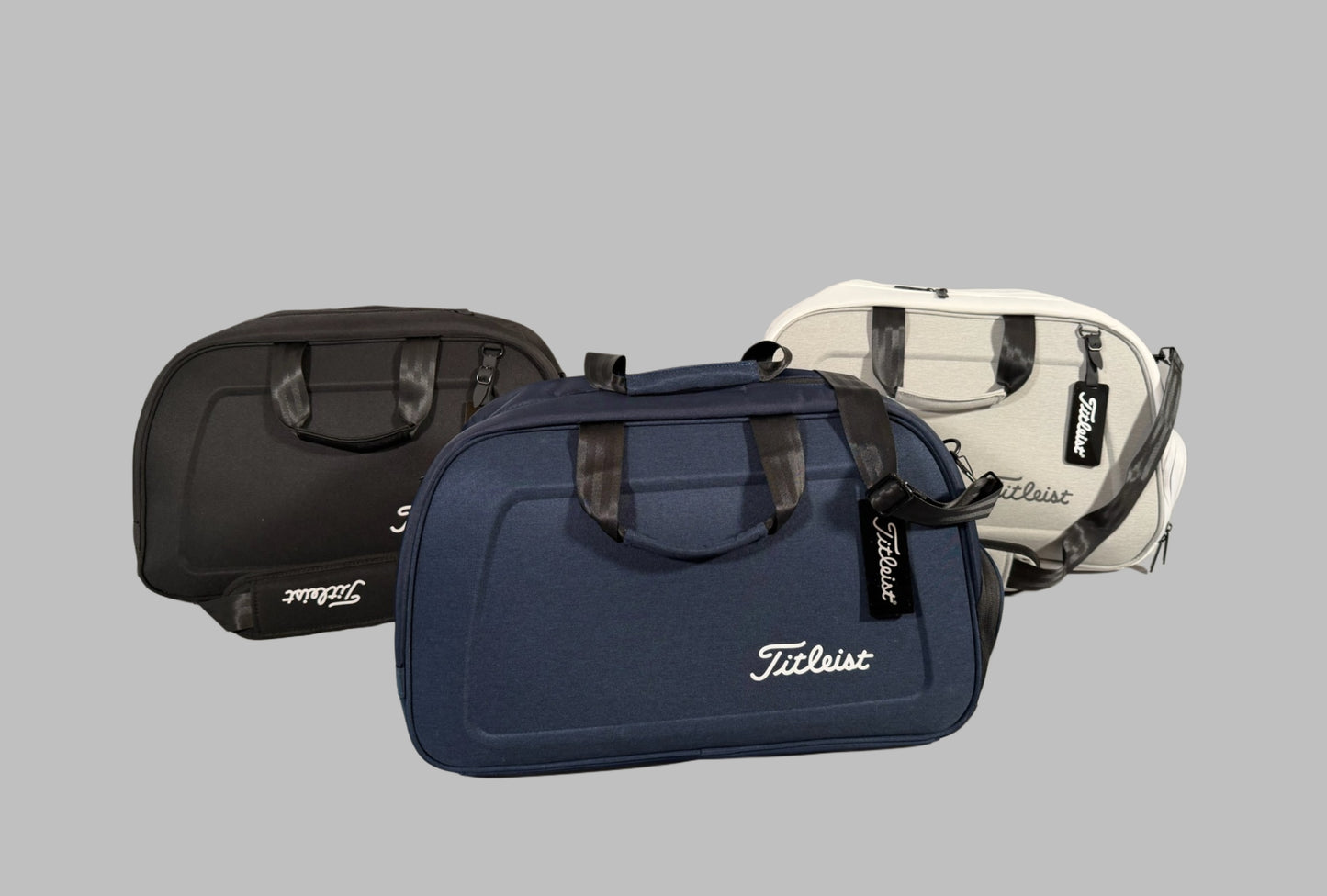 Three golf bags with Titleist branding on a gray background