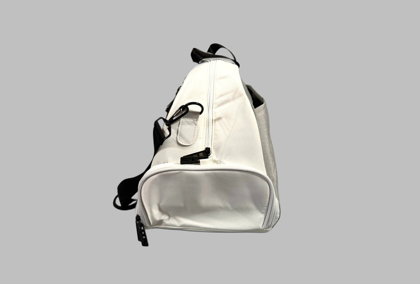 White duffel bag with black accents on a gray background